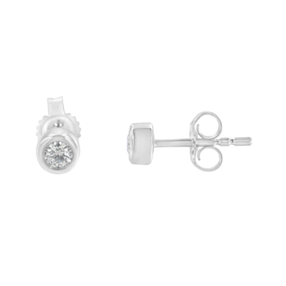 Pair of white metal stud earrings with round white gemstones in bezel settings, shown from front and side angles.