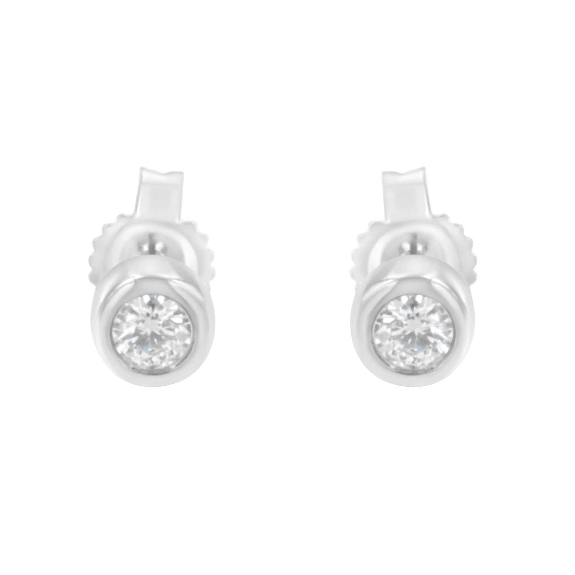 Front view of white metal stud earrings with round white gemstones in bezel settings.