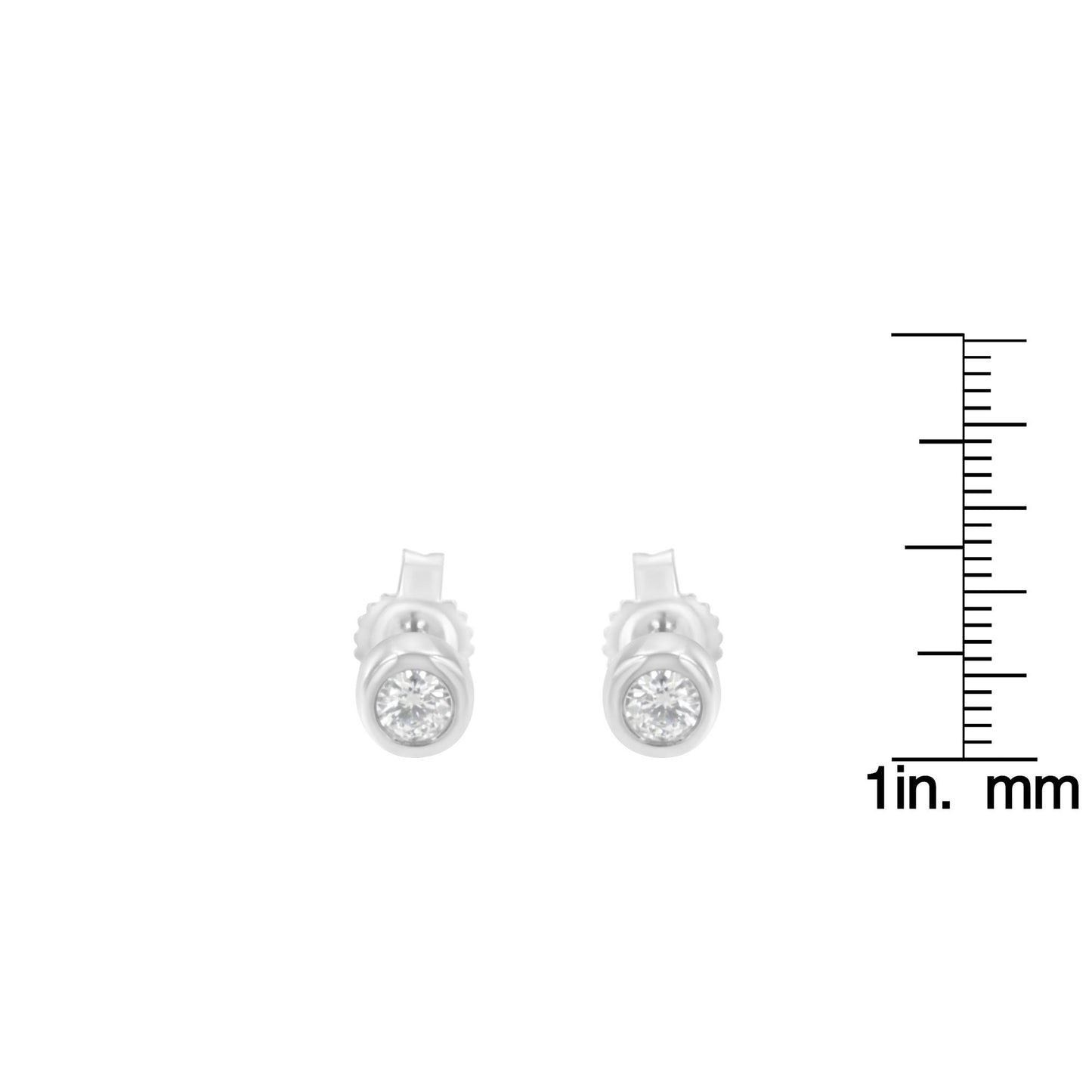 Front view of white metal stud earrings with round white gemstones in bezel settings, shown next to a ruler for size reference.