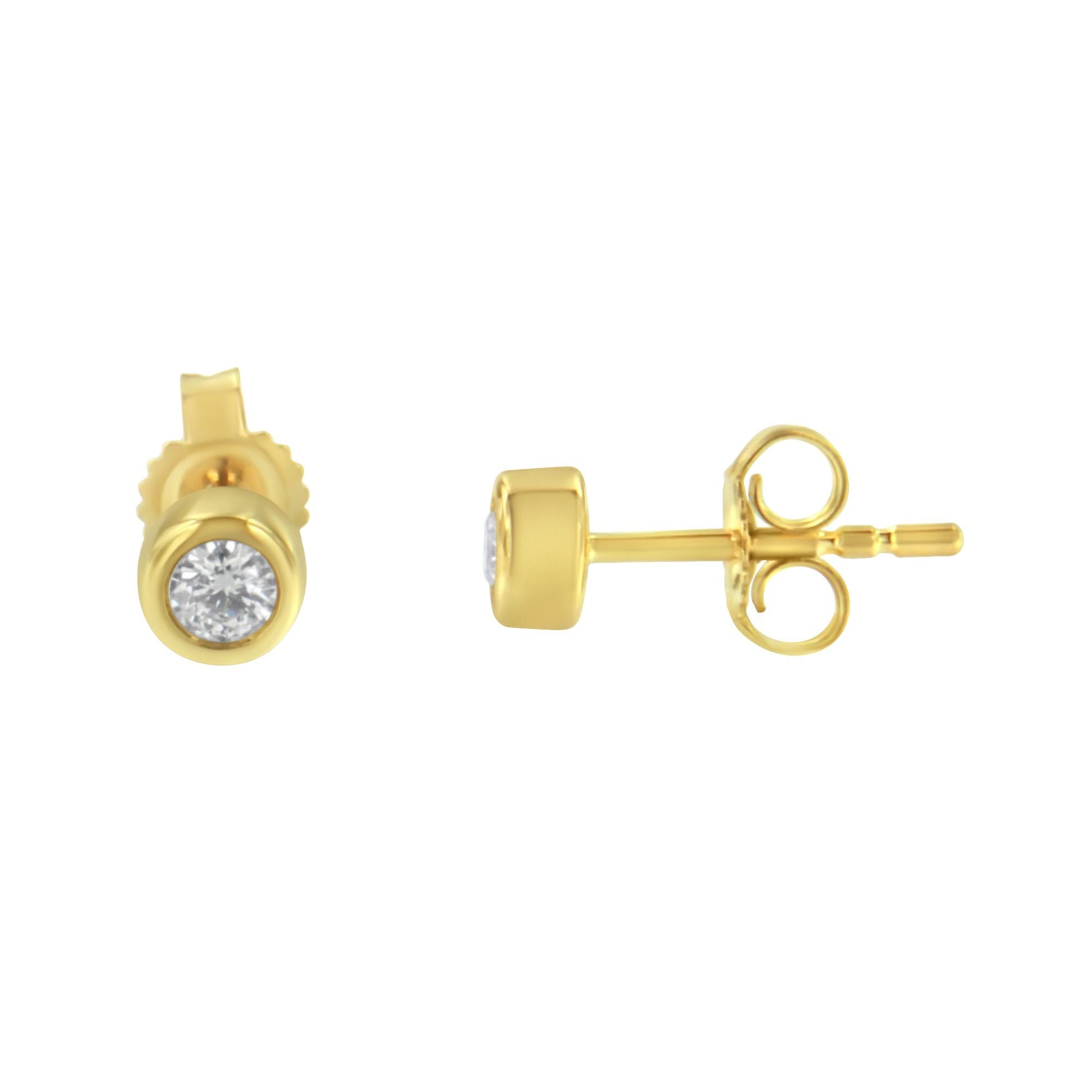 Pair of yellow metal stud earrings with round white gemstones in bezel settings, shown from front and side angle.