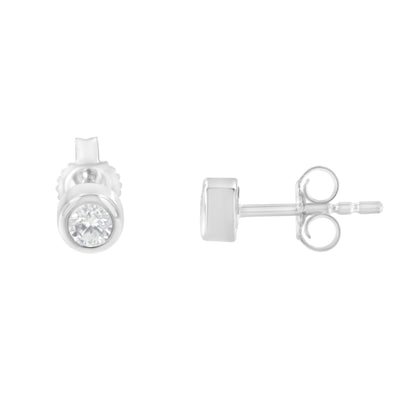Front and side views of white metal stud earrings with round bezel-set white gemstones, shown on a white background.