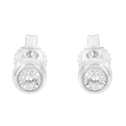 Front view of a pair of white metal stud earrings with round white gemstones in bezel settings.