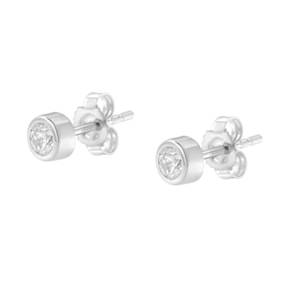 Pair of white metal stud earrings with round white gemstones in bezel settings, shown at a slight angled side view.