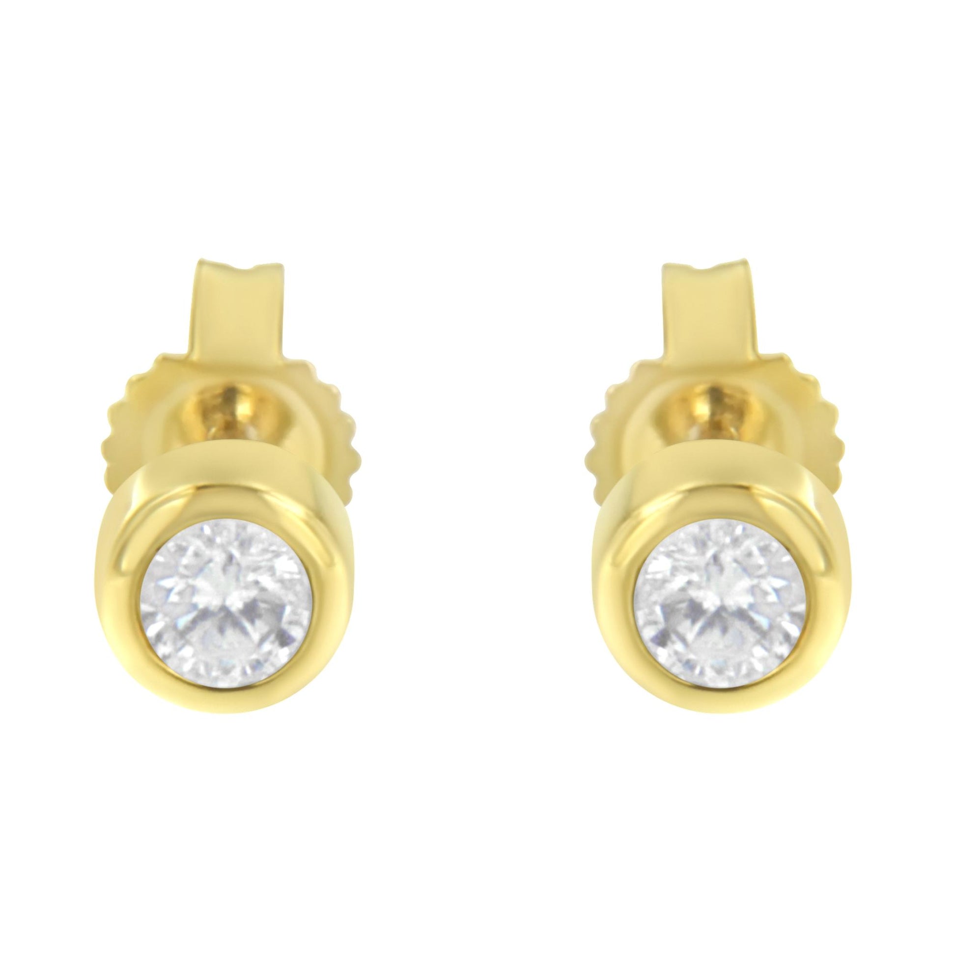 Front view of yellow metal stud earrings with round white gemstones in bezel settings.