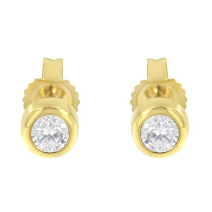 Front view of yellow metal stud earrings with round white gemstones in bezel settings.