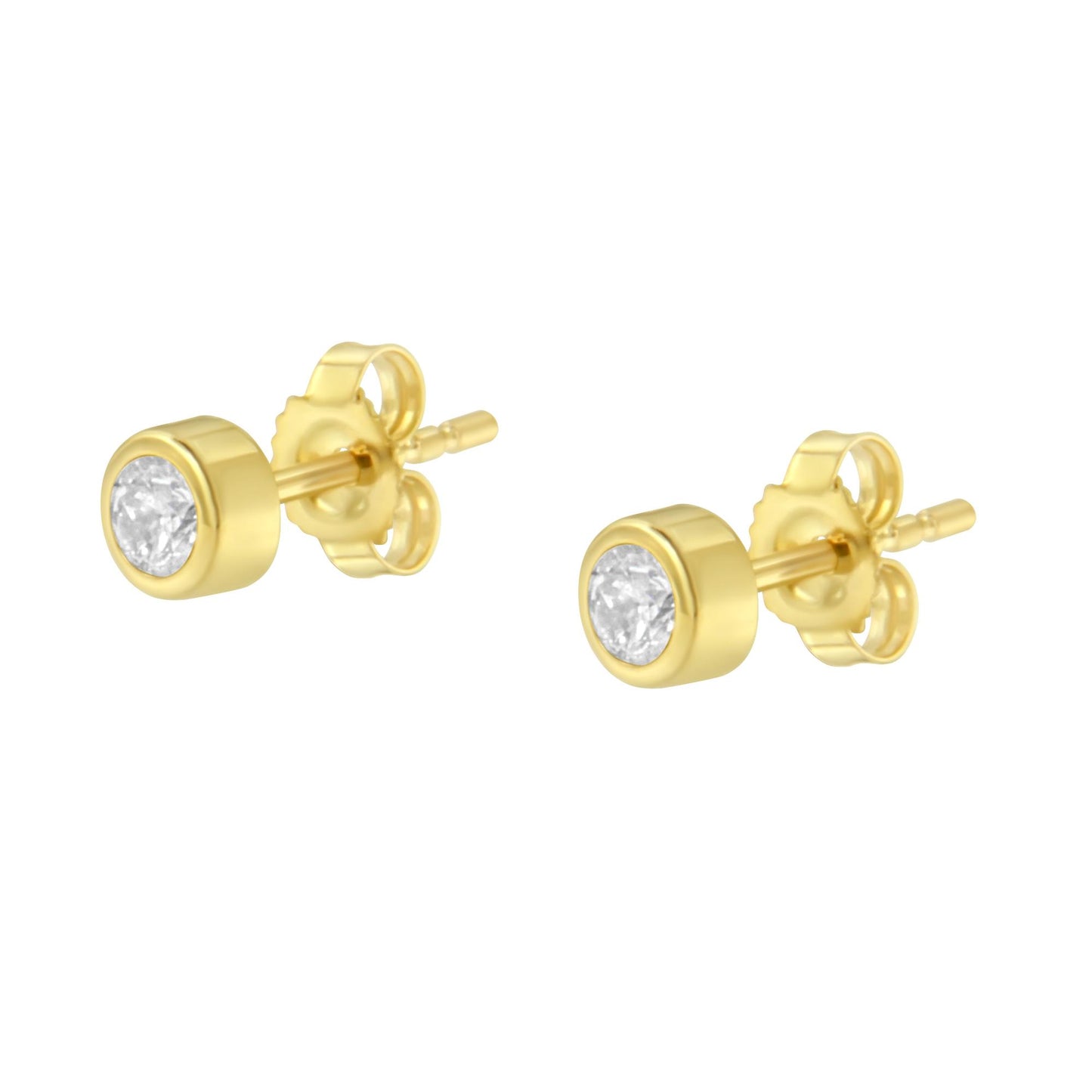 Pair of yellow metal stud earrings with round white gemstones in bezel settings, shown at a slight angle.