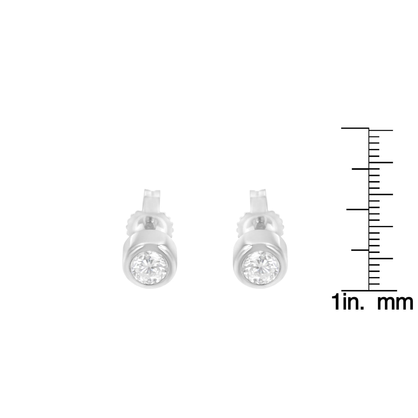 Front view of white metal stud earrings with round white gemstones in bezel settings, shown with a ruler for size reference.
