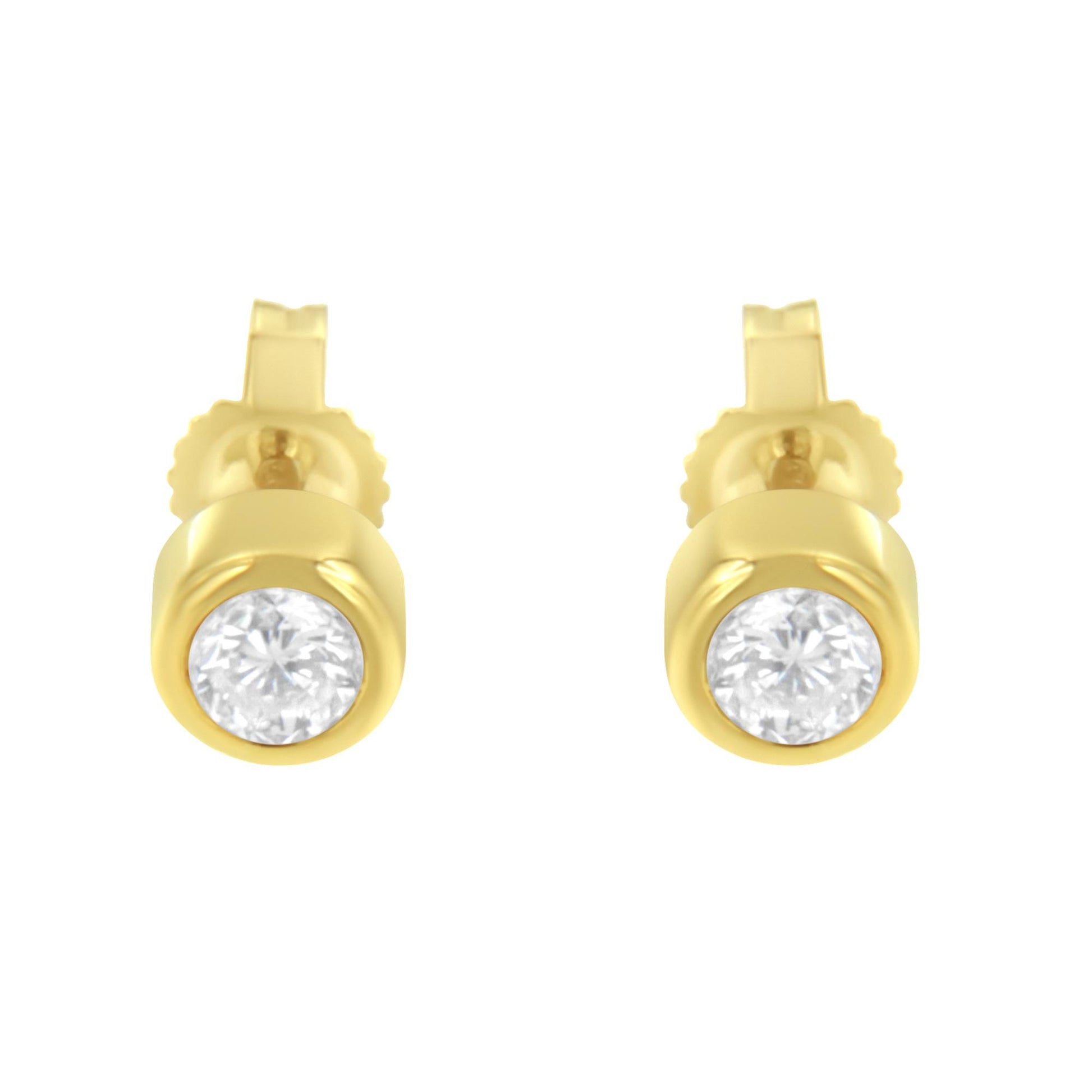 Front view of yellow metal stud earrings with round white gemstones in bezel settings.