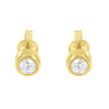 Front view of yellow metal stud earrings with round white gemstones in bezel settings.