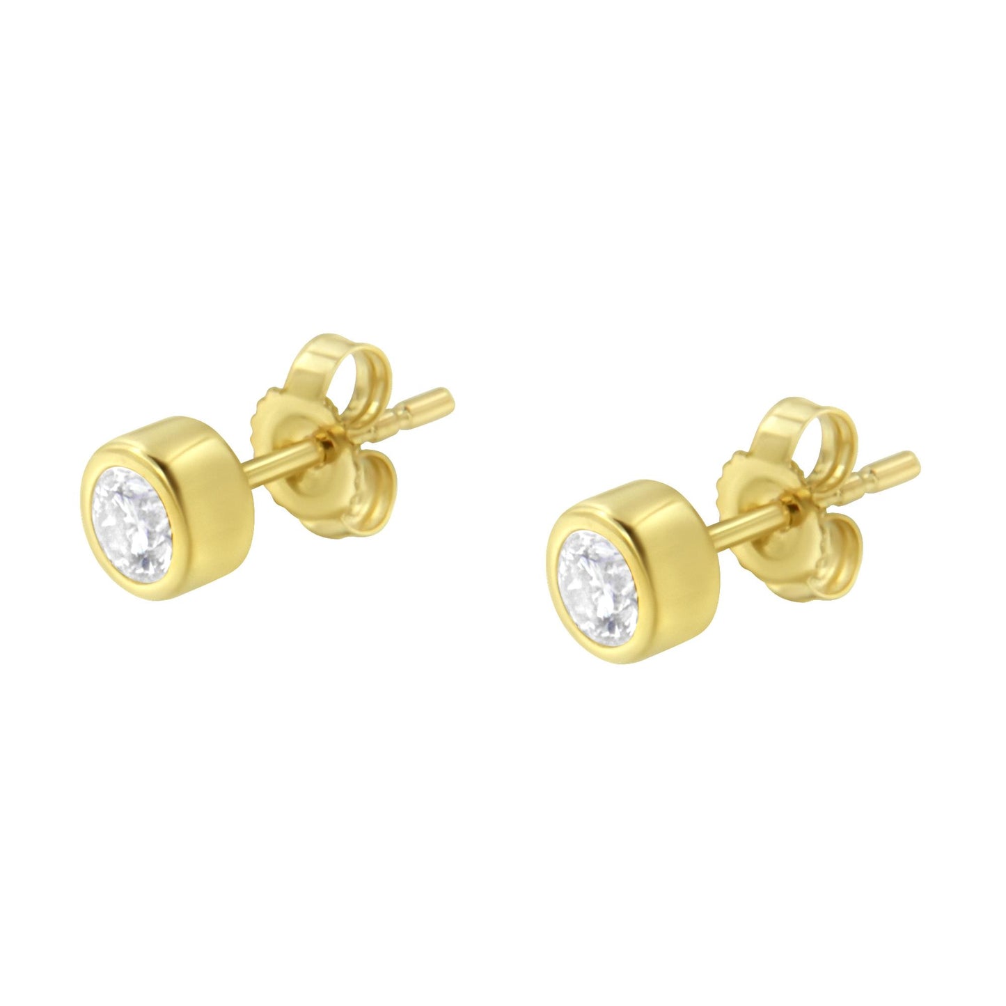 Pair of yellow metal stud earrings with round white gemstones in bezel settings, angled front view.