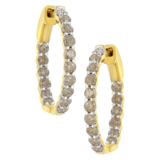Pair of yellow metal hoop earrings set with round prong-set brownish gemstones, shown from an angled front view.