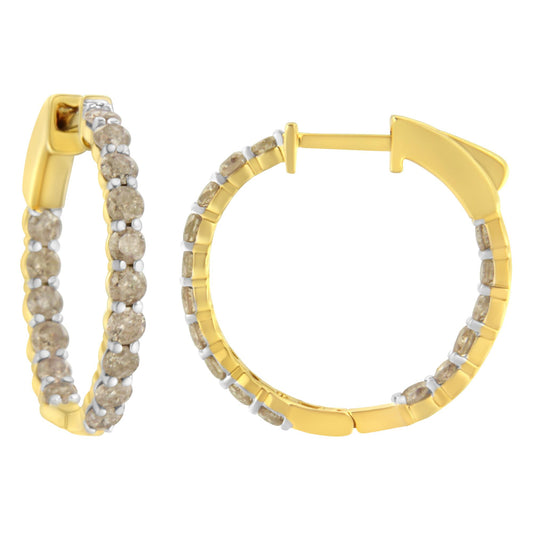 Close-up front and side views of yellow metal hoop earrings set with round brownish gemstones in prong settings.
