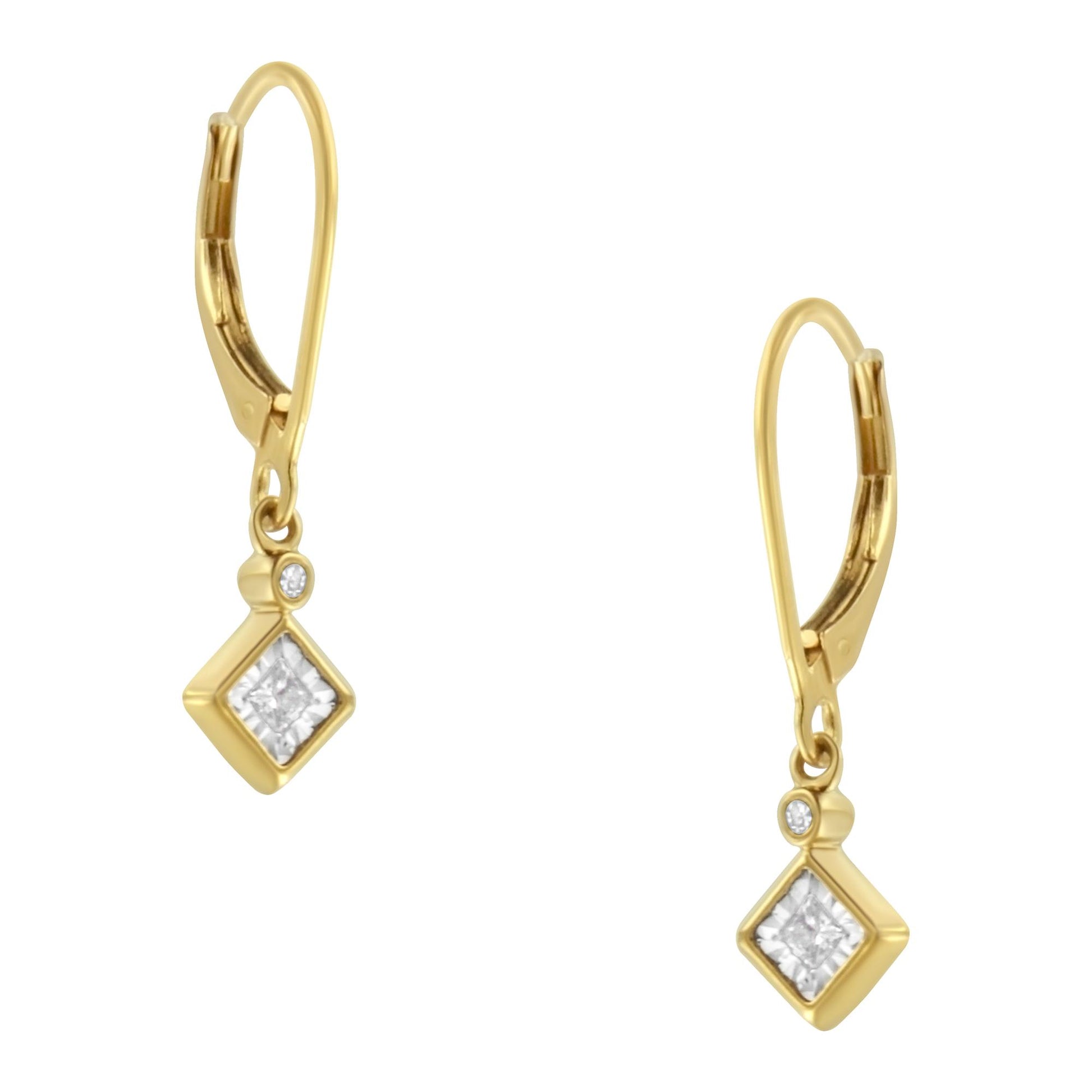 Front-facing view of a pair of yellow and white metal earrings featuring one princess-shaped white gemstone in a miracle setting and one round-shaped white gemstone in a bezel setting on each earring.