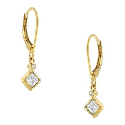 Front-facing view of a pair of yellow and white metal earrings featuring one princess-shaped white gemstone in a miracle setting and one round-shaped white gemstone in a bezel setting on each earring.