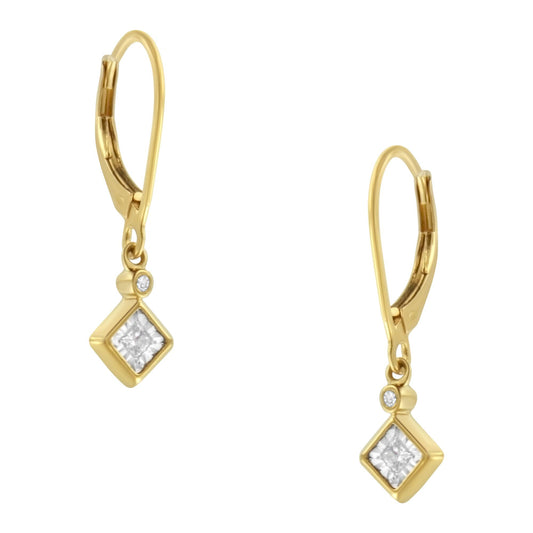 Front-facing view of a pair of yellow and white metal earrings featuring one princess-shaped white gemstone in a miracle setting and one round-shaped white gemstone in a bezel setting on each earring.