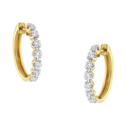 Pair of yellow metal hoop earrings with prong-set white round gemstones, shown from a front angle.