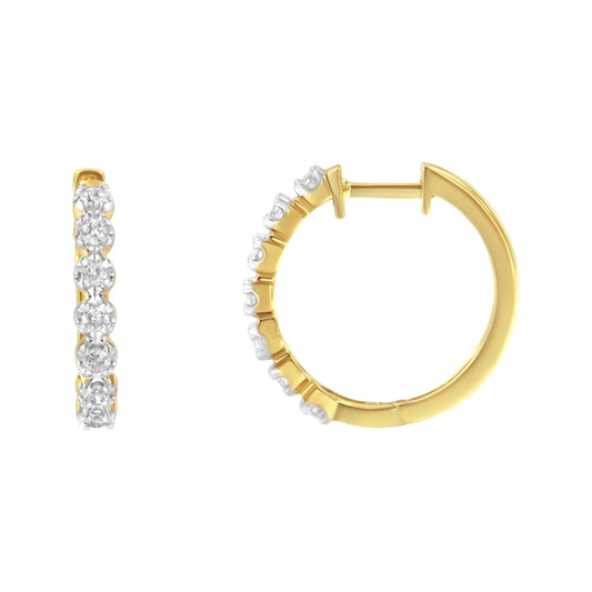 Pair of yellow metal hoop earrings with white round gemstones in prong settings, shown from front and side angles on a white background.