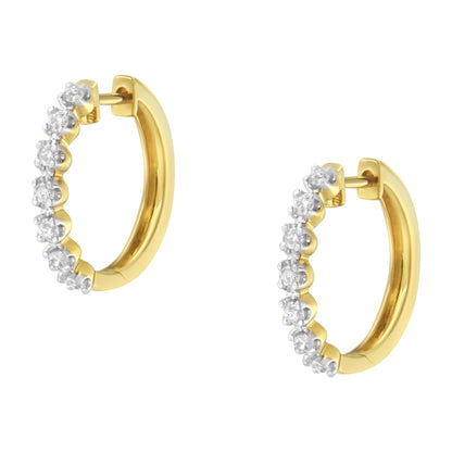 Pair of yellow metal hoop earrings with white round gemstones in prong setting, shown against a white background from a front angle.