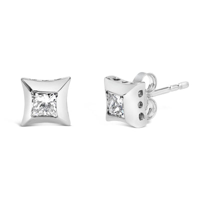 Pair of white metal stud earrings with square red gemstones in bezel setting, one shown front-facing and the other at an angle.