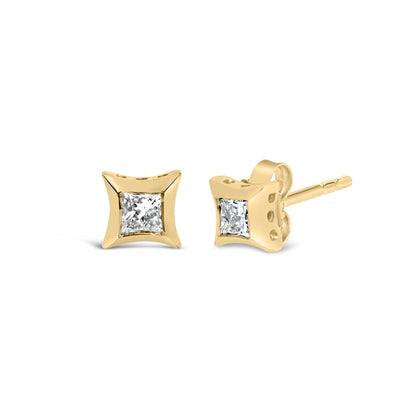 Front and side angled view of yellow metal stud earrings with princess shaped white gemstones in invisible settings.