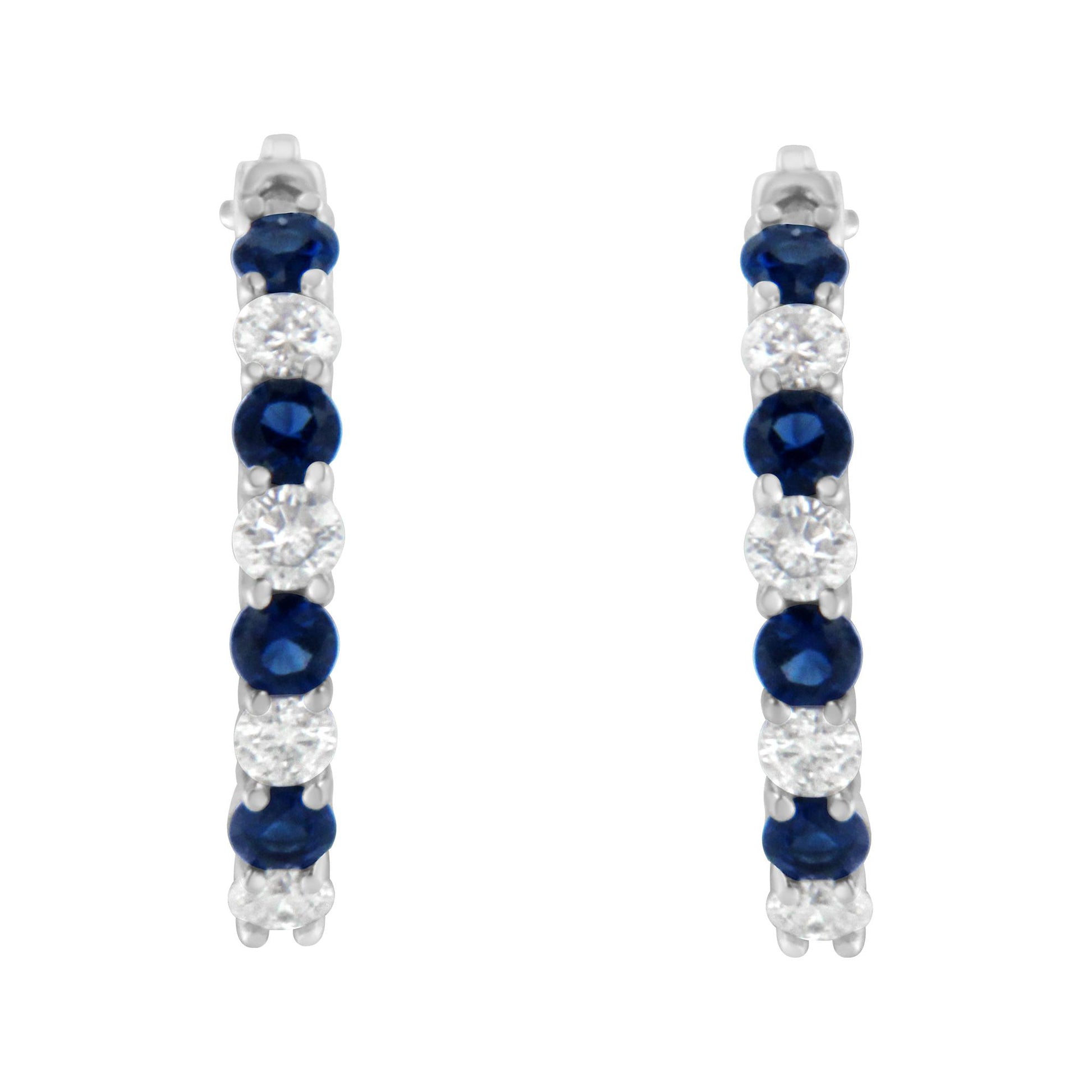 Front view of white metal hoop earrings with alternating round blue and white gemstones in prong settings.