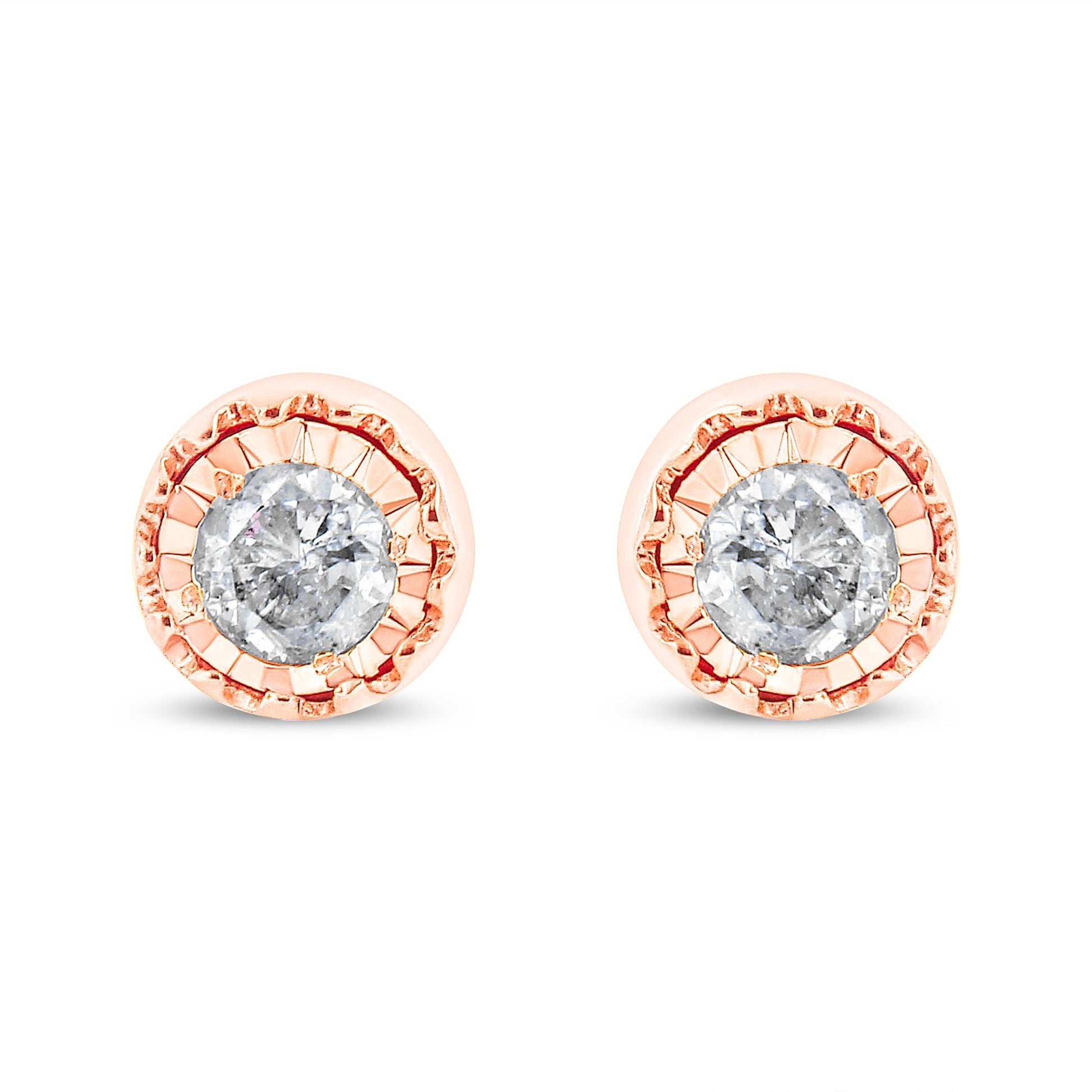 Front facing view of a pair of rose metal stud earrings each featuring a round white gemstone in a miracle setting.