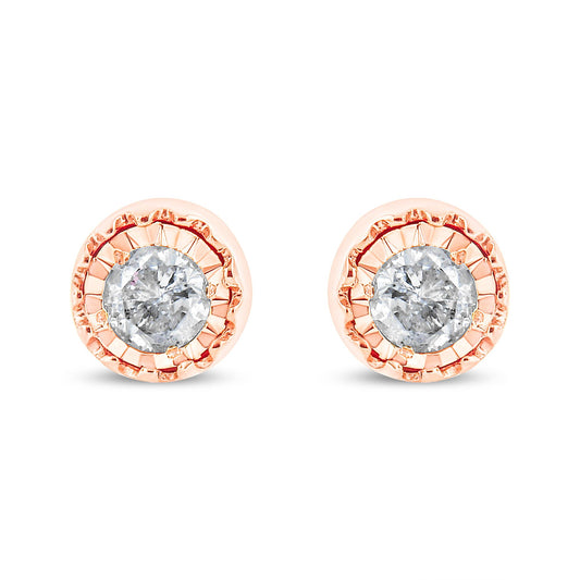 Front facing view of a pair of rose metal stud earrings each featuring a round white gemstone in a miracle setting.