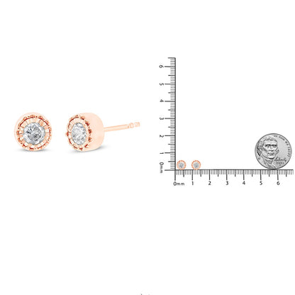 Rose-colored stud earrings with round white gemstones in miracle setting shown from the side and front, alongside a ruler and coin for size reference.