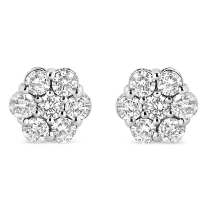 Front view of a pair of white metal floral-shaped stud earrings featuring round white gemstones in prong and channel settings.