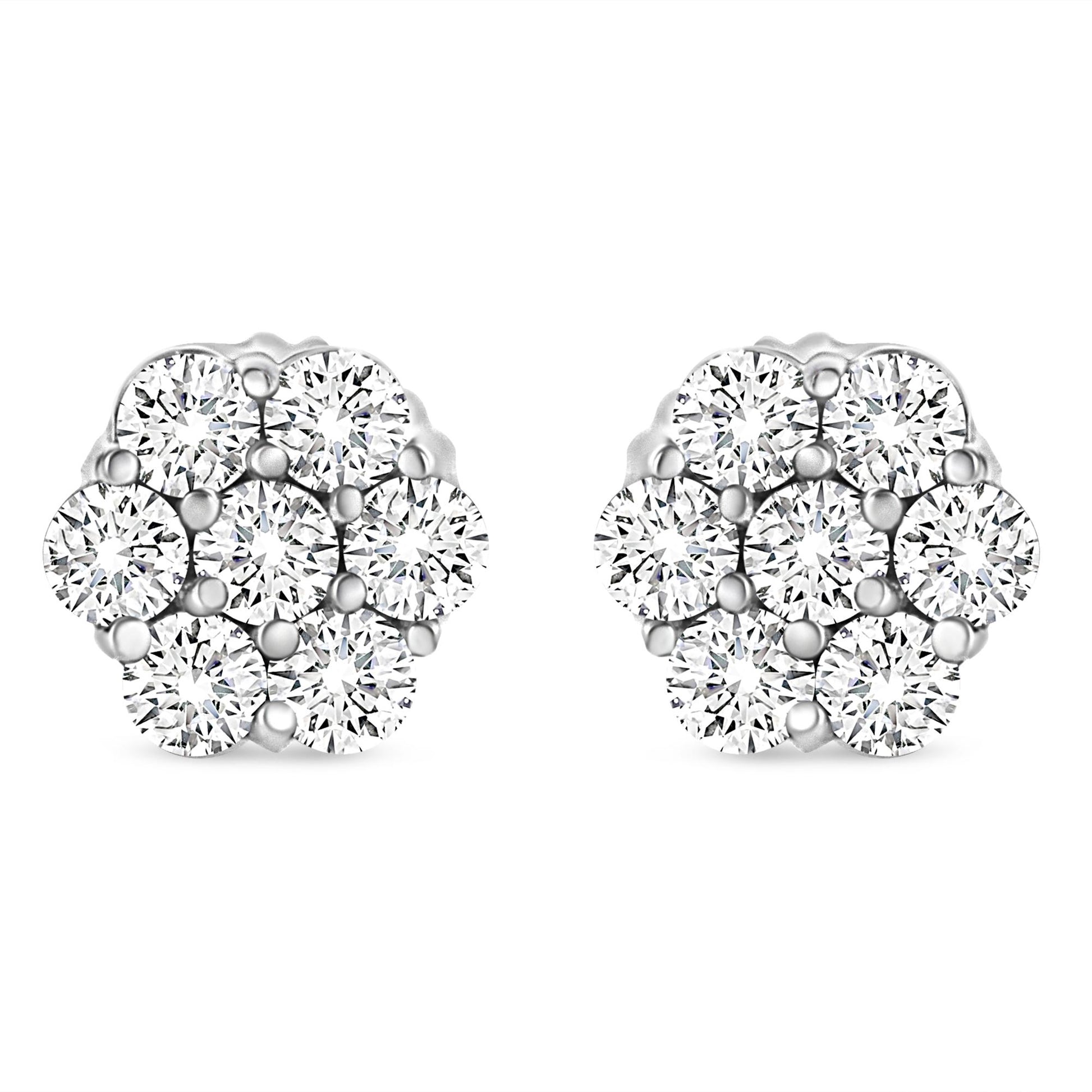 Front angle view of white metal cluster earrings with multiple round white gemstones in prong settings.