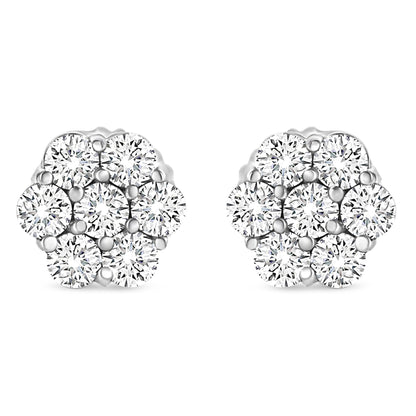 Front angle view of white metal cluster earrings with multiple round white gemstones in prong settings.