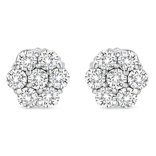 Front angle view of white metal cluster earrings with multiple round white gemstones in prong settings.