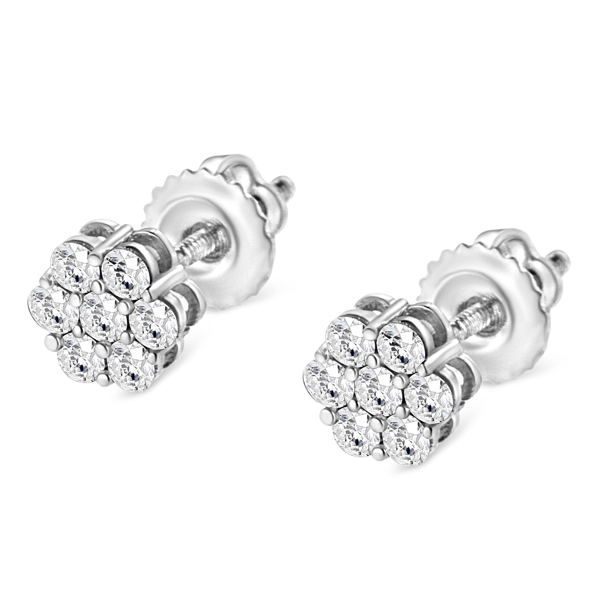 Close-up angle of a pair of white metal stud earrings with clusters of round white gemstones in a prong setting.