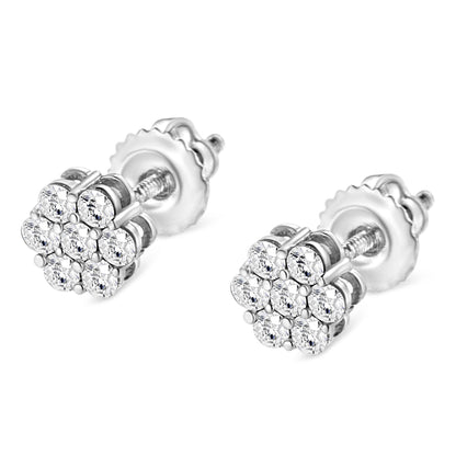 Close-up angle of a pair of white metal stud earrings with clusters of round white gemstones in a prong setting.