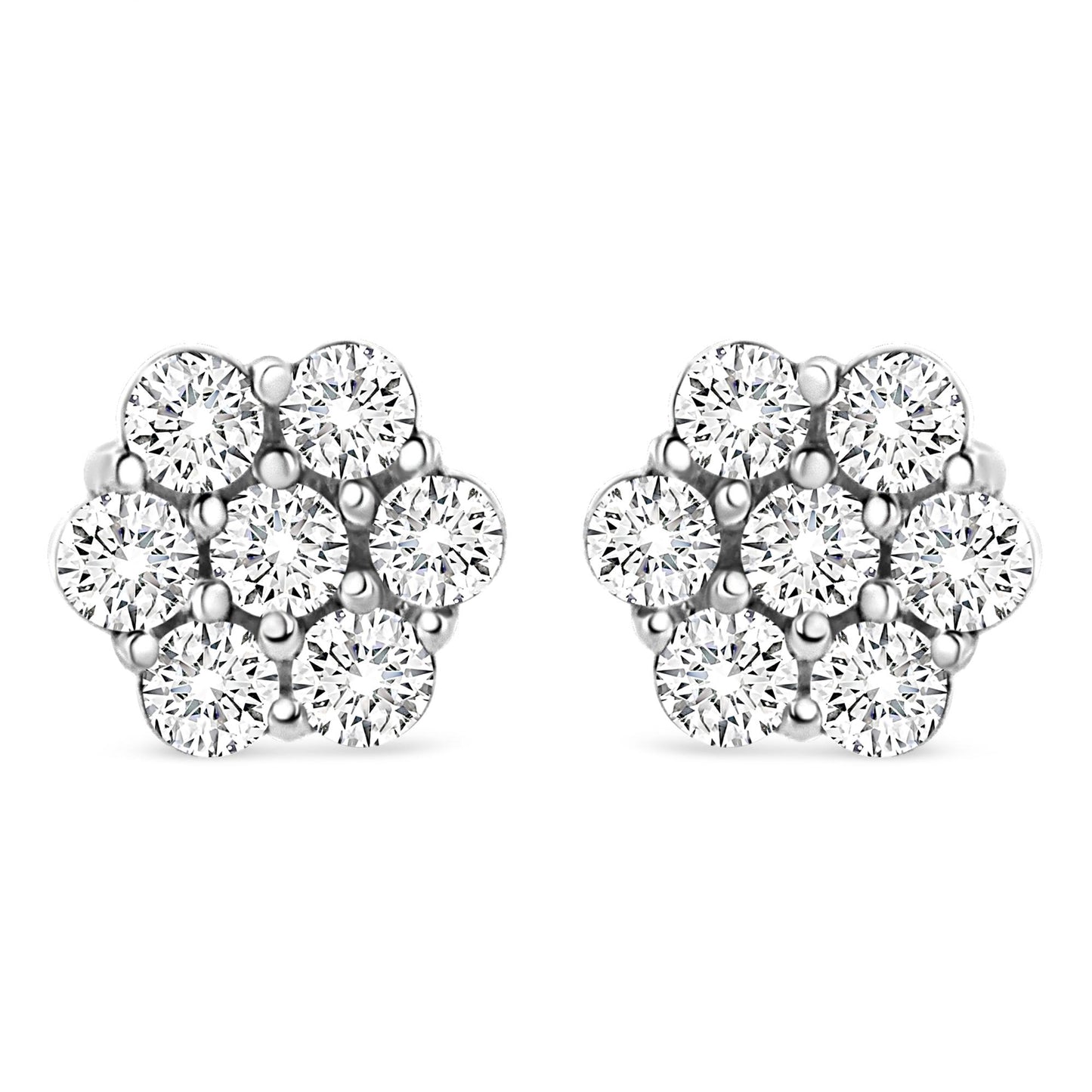 Front view of white metal stud earrings shaped like flowers with round white gemstones in prong settings.