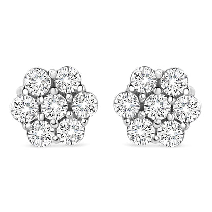 Front view of white metal stud earrings shaped like flowers with round white gemstones in prong settings.