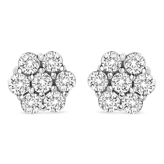 Front view of white metal stud earrings shaped like flowers with round white gemstones in prong settings.