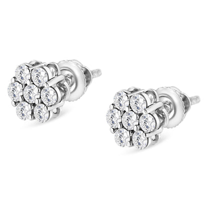 Pair of white metal stud earrings with round white gemstones in prong settings, shown at a slight angle.