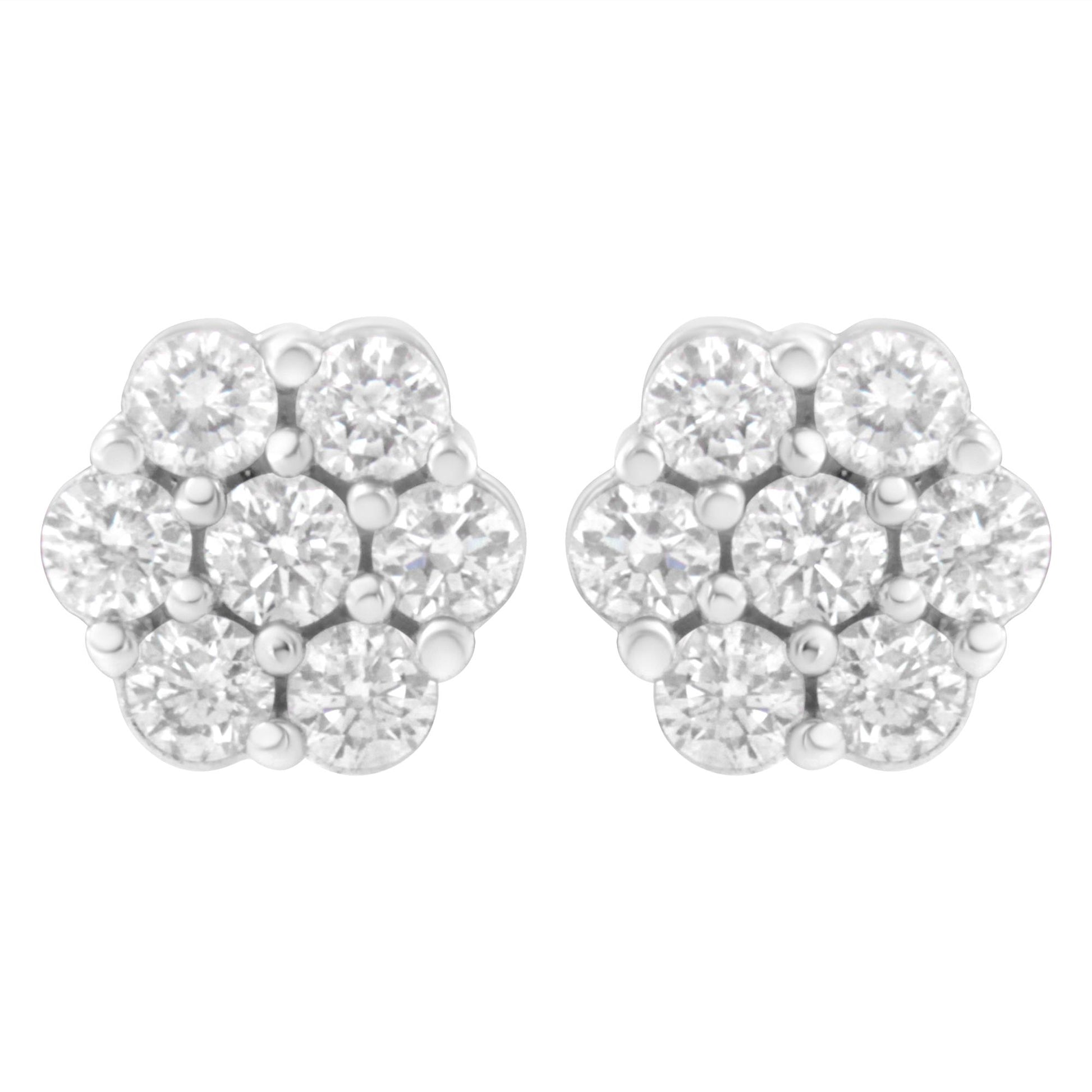 Front view of white metal cluster earrings with round white gemstones in prong settings.