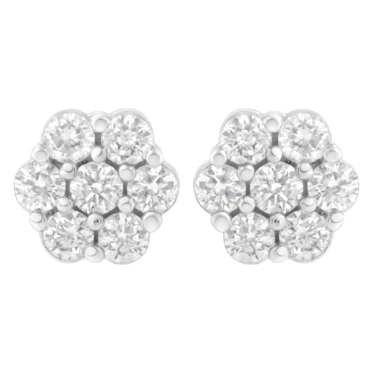Front view of white metal cluster earrings with round white gemstones in prong settings.