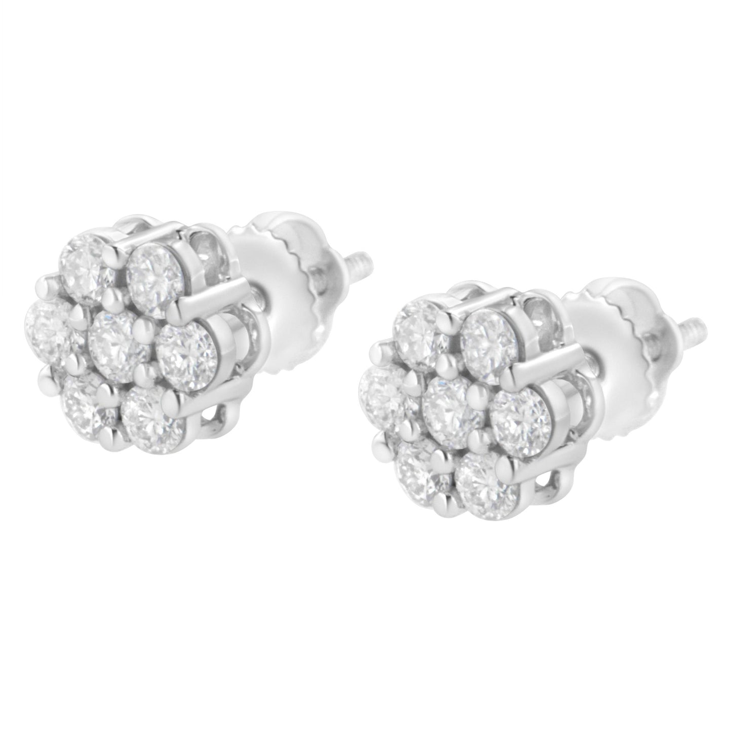 Pair of white metal stud earrings with cluster of round white gemstones in prong settings, shown in close-up angled view.