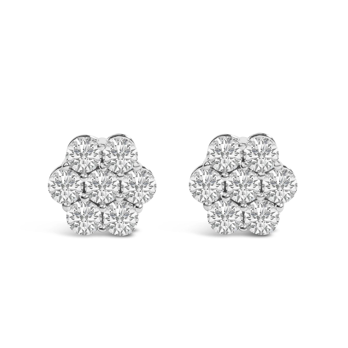 Pair of white metal flower-shaped earrings with round white gemstones in prong settings, front-facing angle.