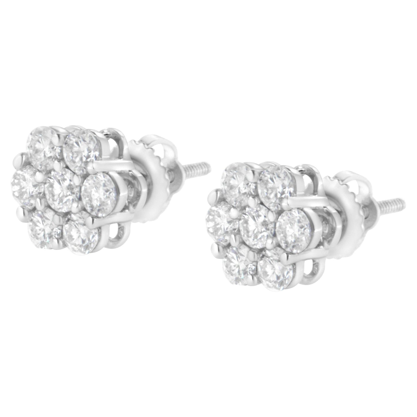 Pair of white metal stud earrings with clusters of round white gemstones in prong settings, shown at a slight angle.