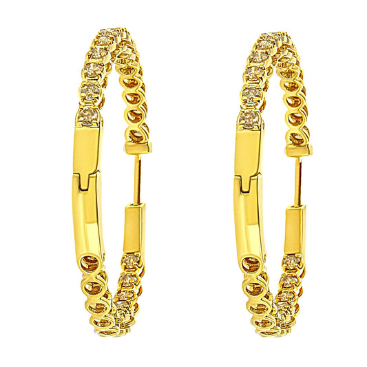 Pair of yellow metal hoop earrings with round champagne-colored gemstones in prong settings, shown from a front angle.