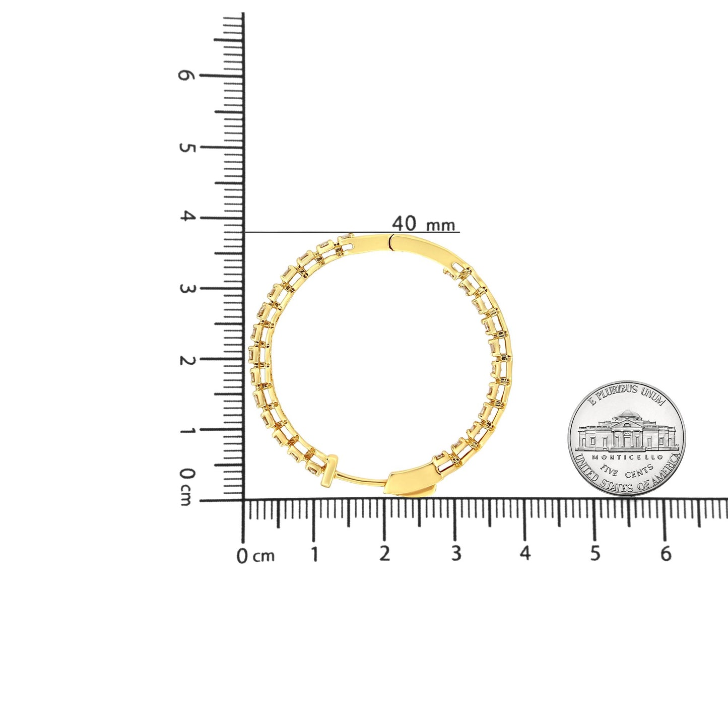Top-down view of a yellow metal hoop earring set with round prong-set champagne-colored gemstones, shown on a ruler for size reference.