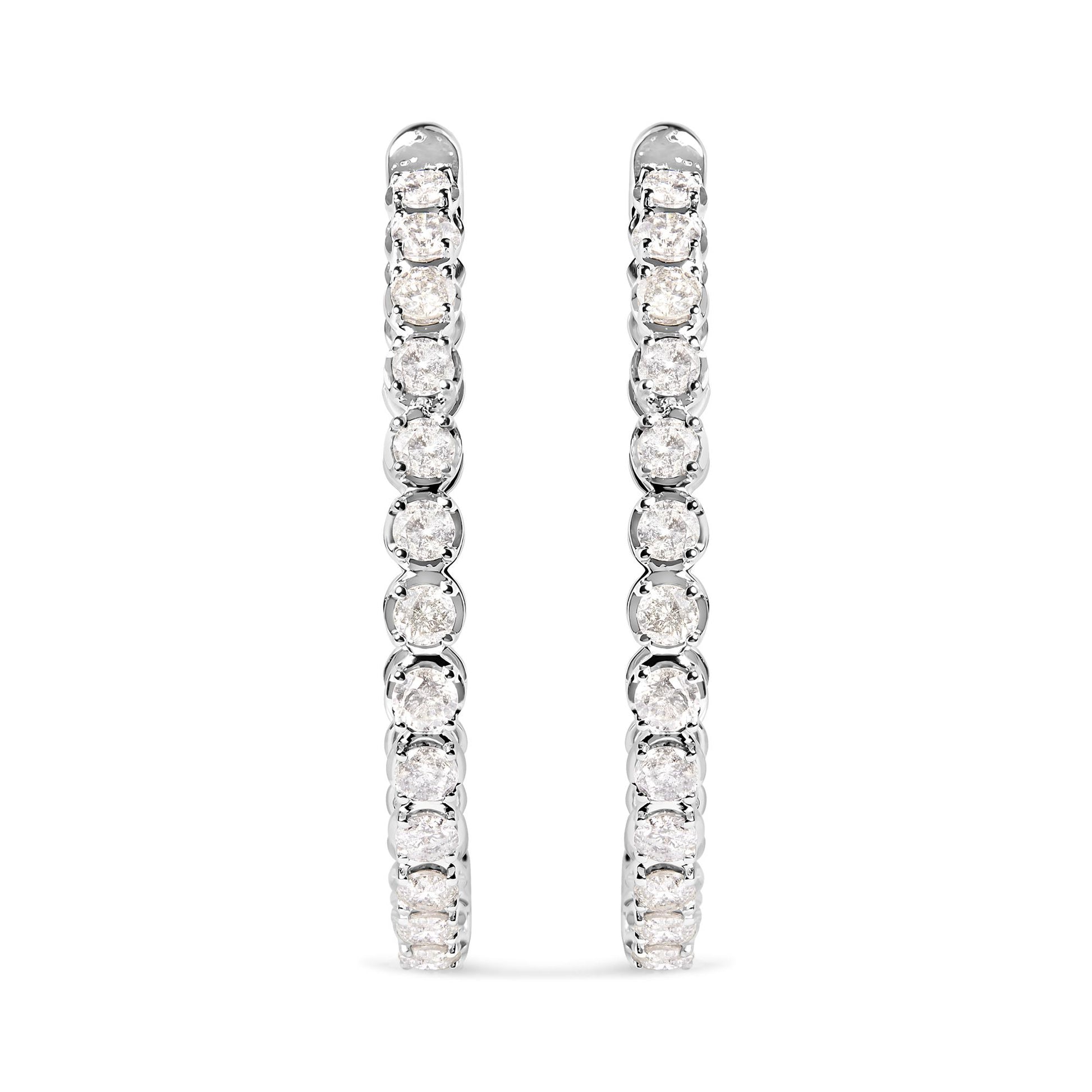 Pair of white metal hoop earrings with prong-set round white gemstones, shown from front angle on white background.