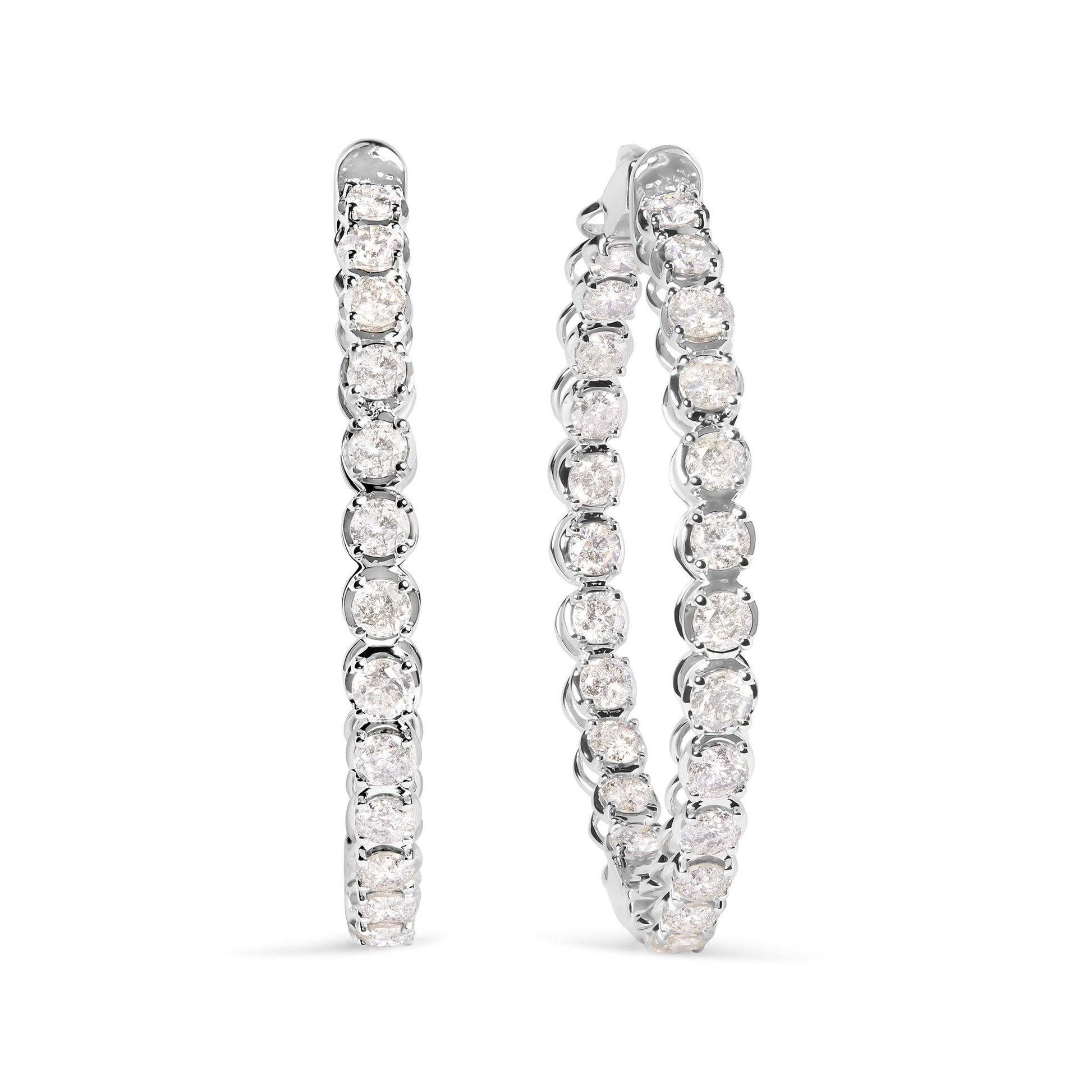 Pair of white metal hoop earrings set with round white gemstones in prong settings, shown from a front angle.