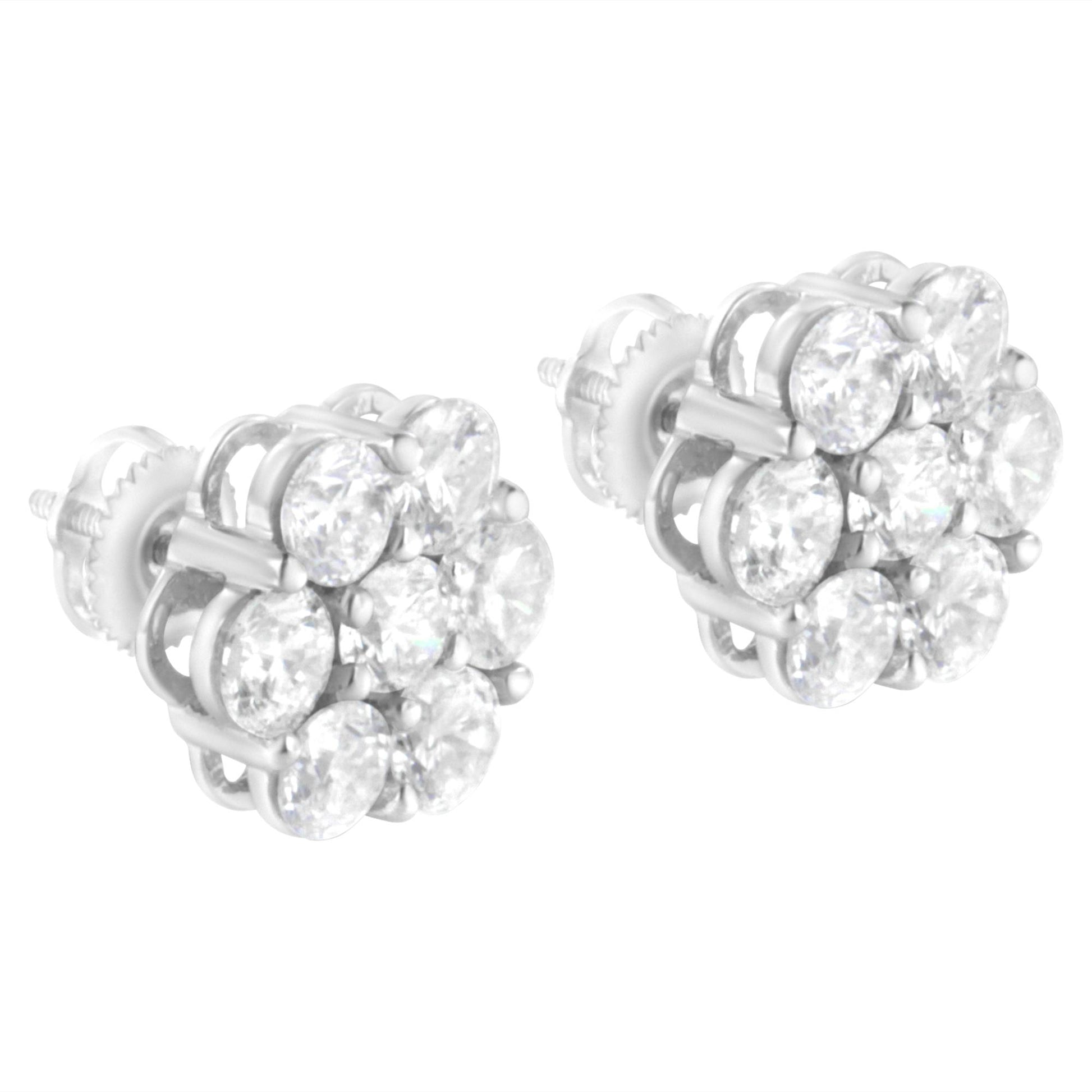 Close-up front angle of white metal stud earrings featuring clusters of round white gemstones in shared prong settings.