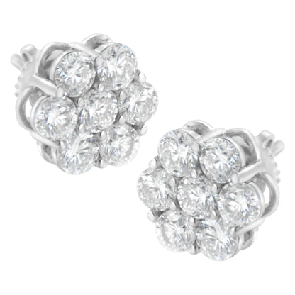 Pair of white metal stud earrings with round white gemstones in prong settings arranged in a cluster, shown from a front angle.