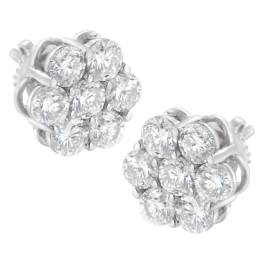 Pair of white metal stud earrings with round white gemstones in prong settings arranged in a cluster, shown from a front angle.